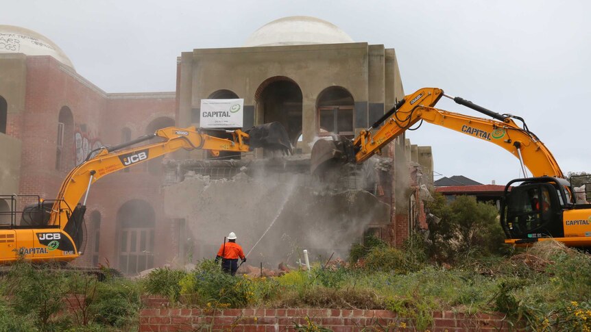 Two yellow diggers demolish the Taj on Swan.