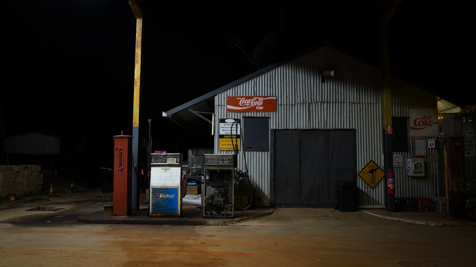 Old pieces of equipment show the age of a roadhouse, with paint peeling off signs after years of exposure to harsh weather.