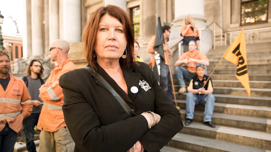 Pam Gurner-Hall stands in front of union workers at Parliament House.