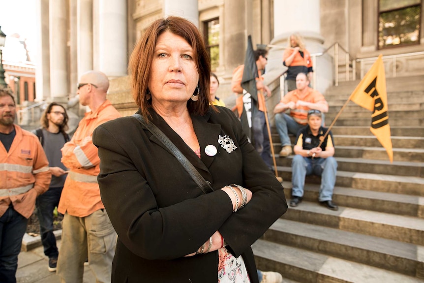 Pam Gurner-Hall stands in front of union workers at Parliament House.