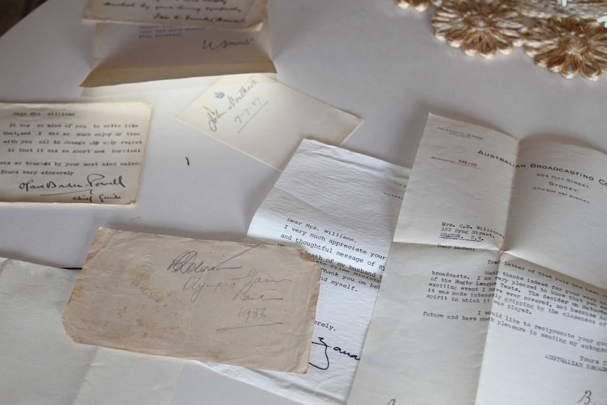 Old letters lie strewn on a table