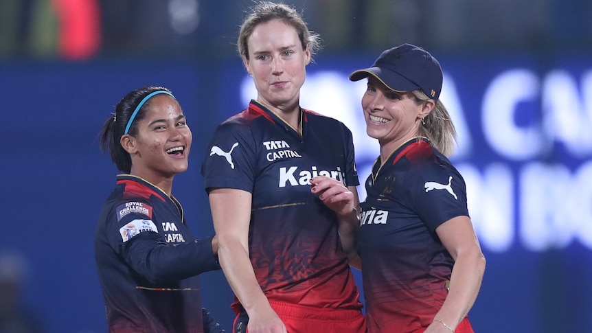 Ellyse Perry celebrates a WPL wicket with RCB teammates.