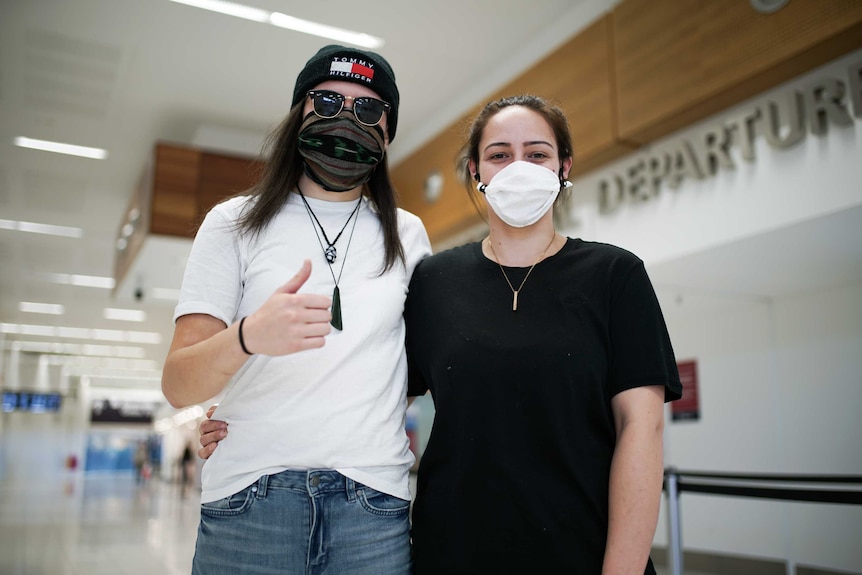 Two women wearing face masks