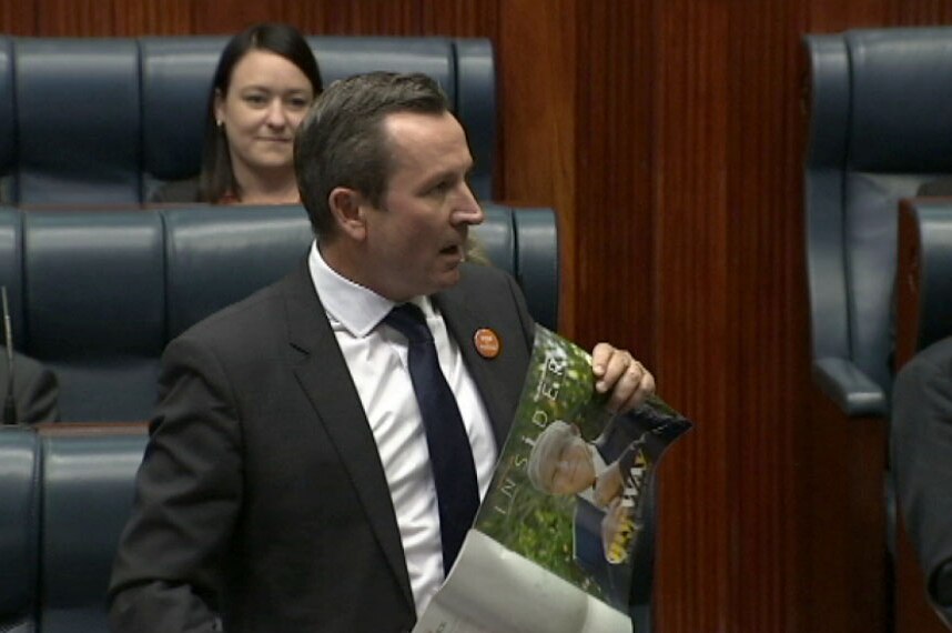 Mark McGowan holds up a magazine while speaking in Parliament.