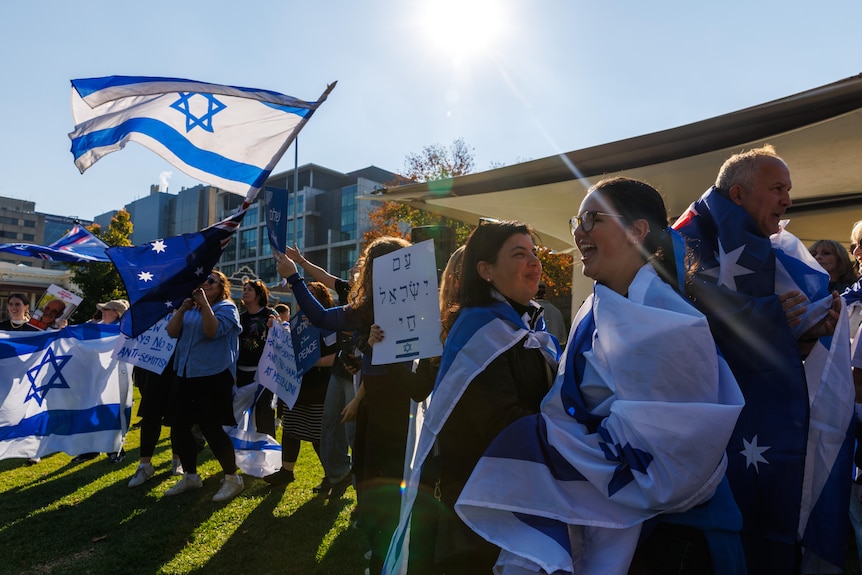 A group of people holding Israel flag. 