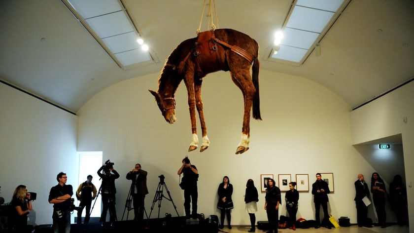 Maurizio Cattelan's work Novecento hangs in the Museum of Contemporary Art in Sydney.