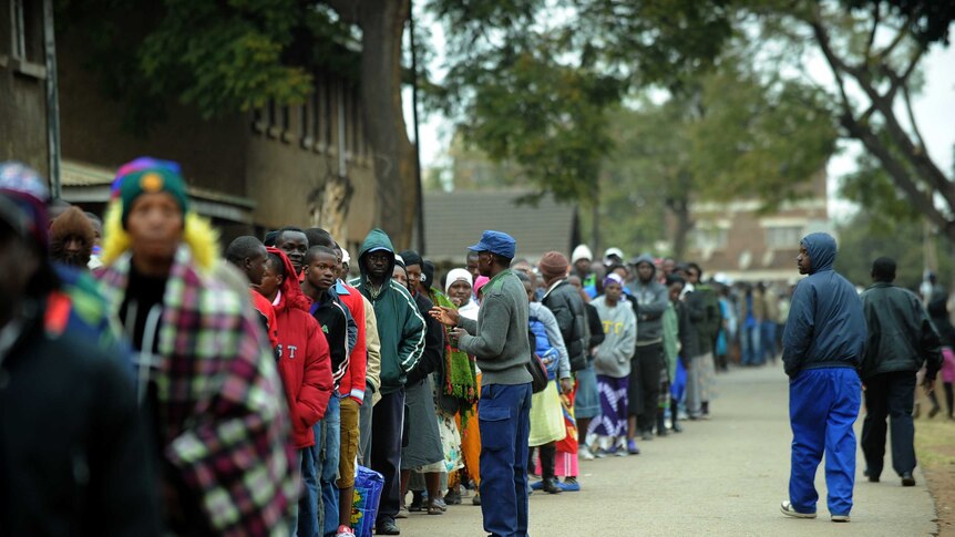 Zimbabweans line up near a polling station in Harare to vote in a general election.