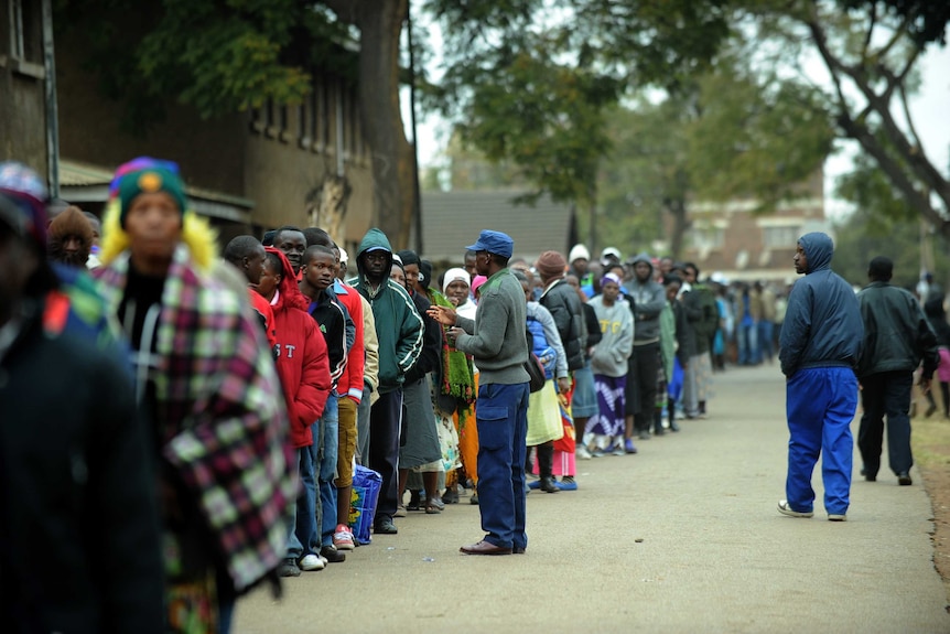 Zimbabweans line up near a polling station in Harare to vote.