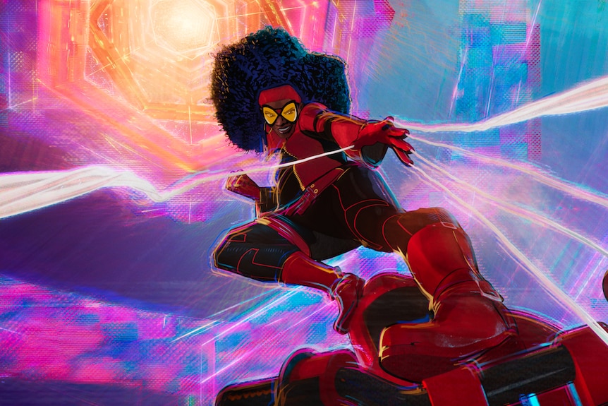Jessica Drew, an animated black woman with an afro wearing a red body suit and yellow goggles, is mid fight sequence.