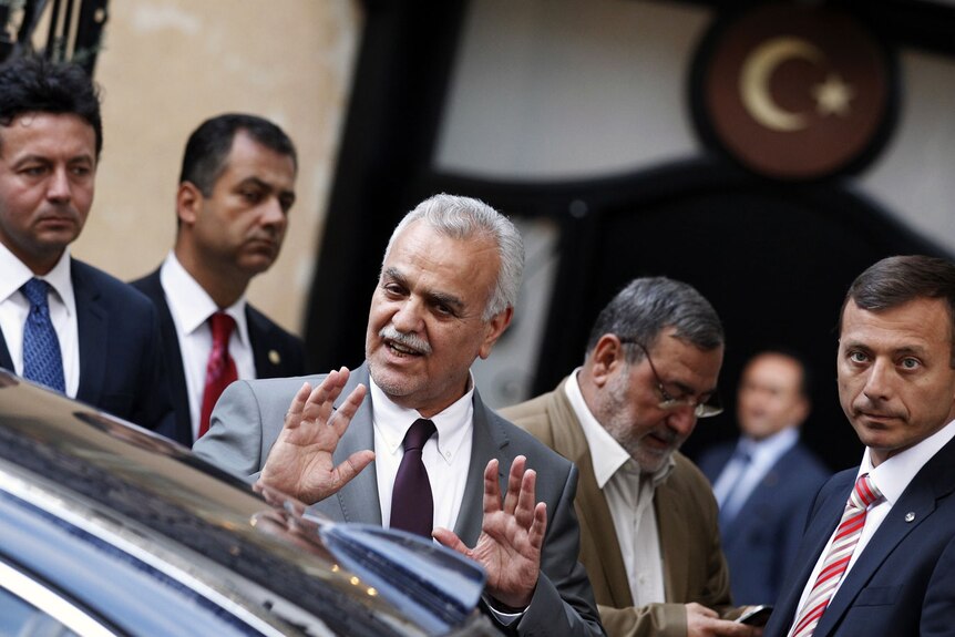 Iraq's fugitive vice-president gestures to supporters