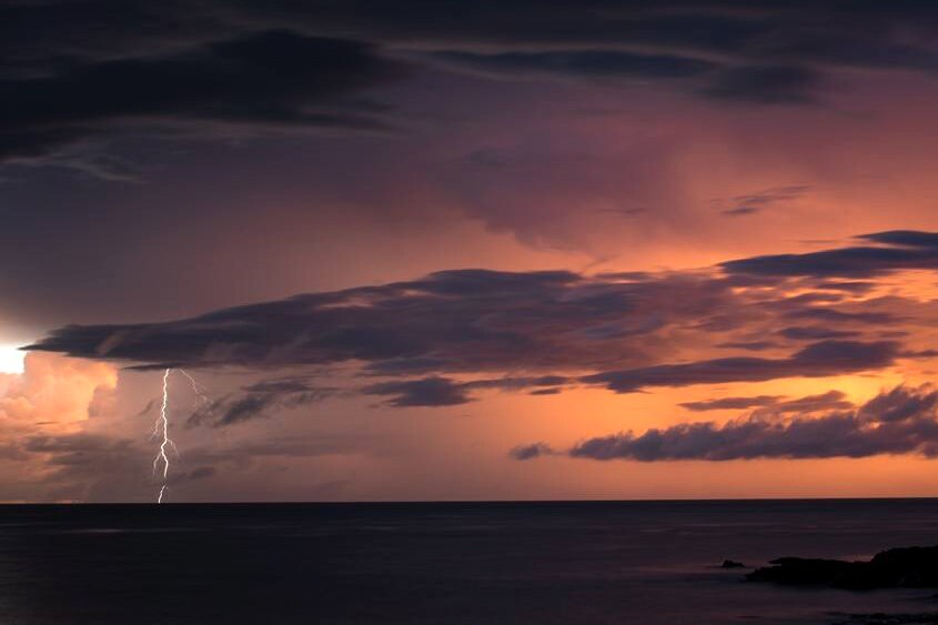 A lightning strike over the ocean illuminates the Kimberley skyline, as a cyclone approaches the coast.