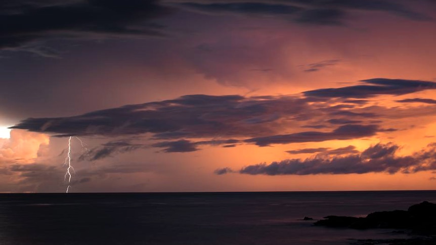 A lightning strike over the ocean illuminates the Kimberley skyline, as a cyclone approaches the coast.