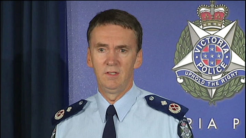 Sir Ken Jones, in a Victoria Police uniform, stands in front of a blue Victoria Police background.