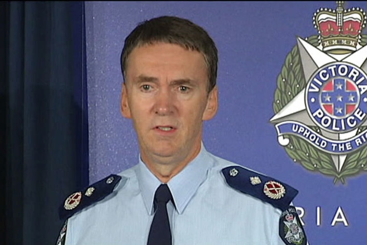 Sir Ken Jones, in a Victoria Police uniform, stands in front of a blue Victoria Police background.