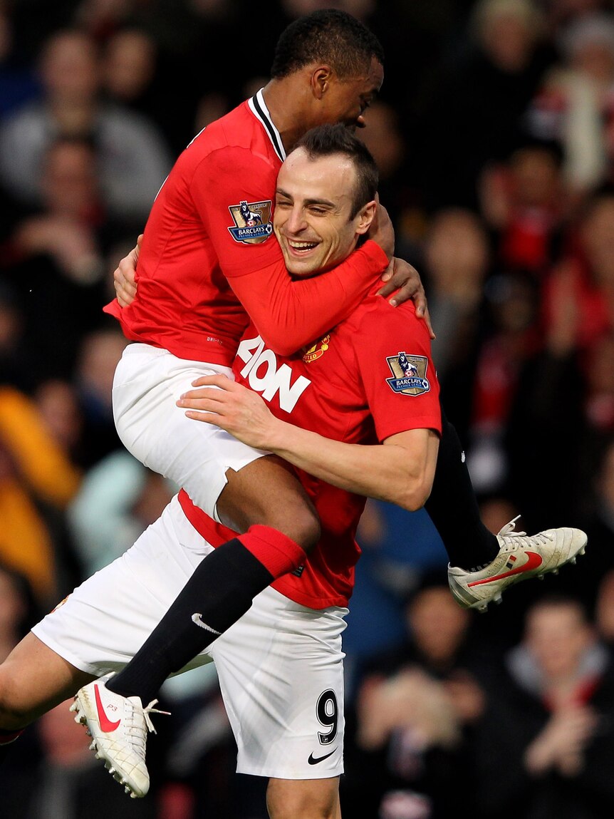 Dimitar Berbatov of Manchester United celebrates scoring with team-mate Patrice Evra