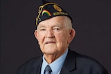 An elderly man in a naval cap with his service medals