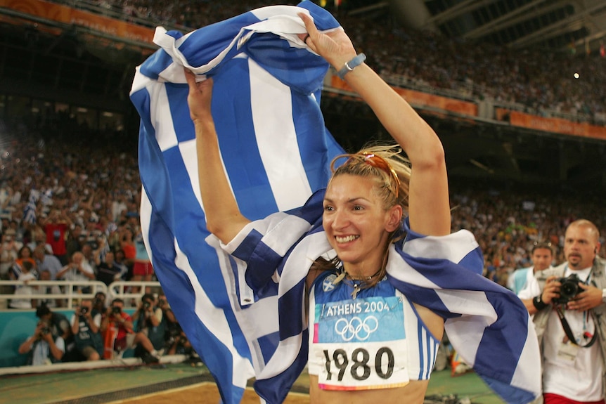 Greece's Fani Halkia celebrates after winning women's 400m hurdles final at the Athens Olympics.