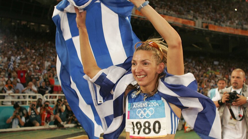 Greece's Fani Halkia celebrates after winning women's 400m hurdles final at the Athens Olympics.
