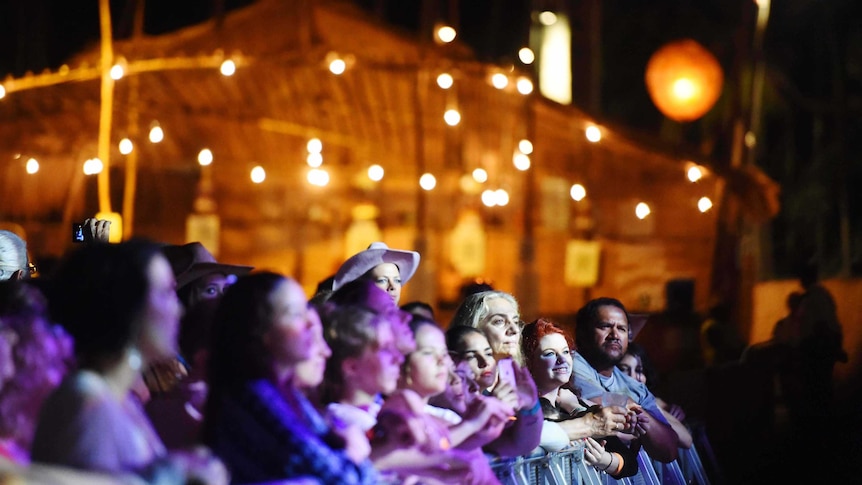 People watching a concert at night