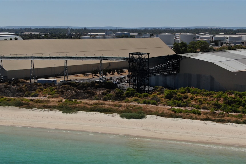 An aerial image showing fire damage to a storage factory near a beach