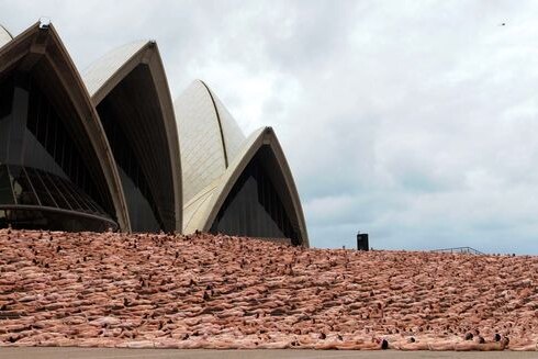 Thousands of people pose nude on the steps of the Sydney Opera House.