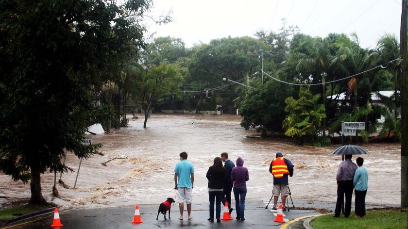 Bystanders watch the rising floodwaters