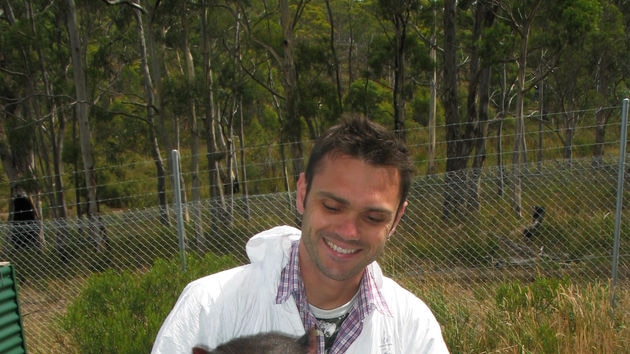 Scientist, Alex Kriess with Cedric the tasmanian devil