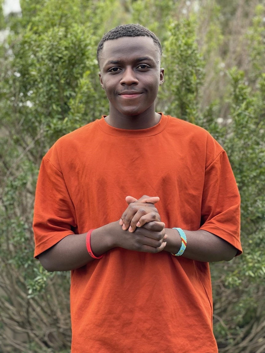 A man wearing an orange shirt.