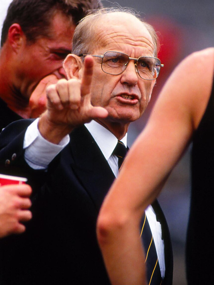 Allan Jeans speaks to his players during an AFL match in 1992