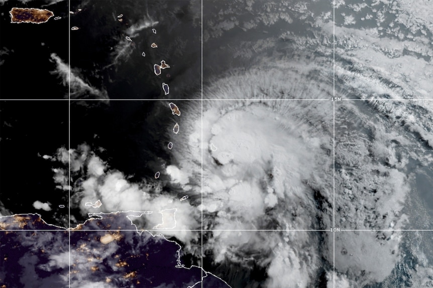 Satellite photos show large clouds swirling over the Caribbean