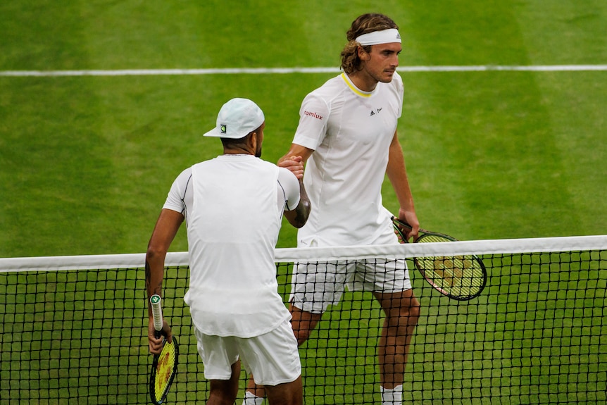 Two tennis plays shake hands after a match