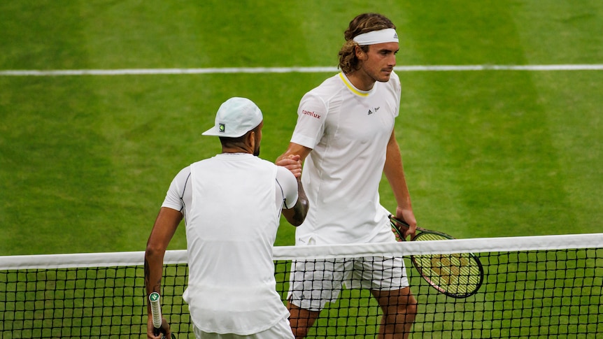 Two tennis plays shake hands after a match