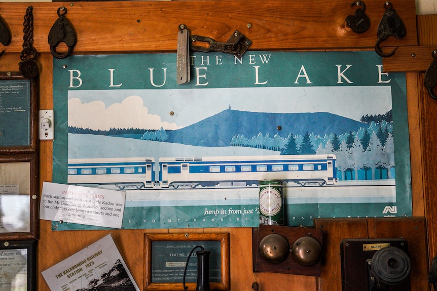 an old poster showing a blue lake with white jetty 