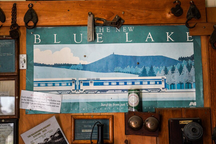 an old poster showing a blue lake with white jetty 