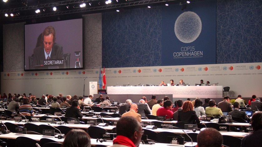 Delegates sit in the main plenary hall at the Bella Centre during the UN Climate Change Conference