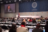Delegates sit in the main plenary hall at the Bella Centre during the UN Climate Change Conference