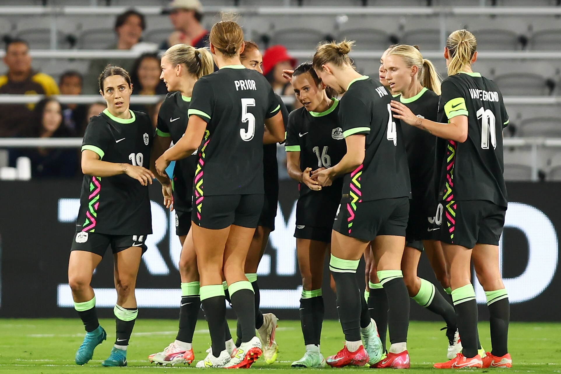 Hayley Raso (centre) is surrounded by Australia Matildas teammates during a game against Colombia.