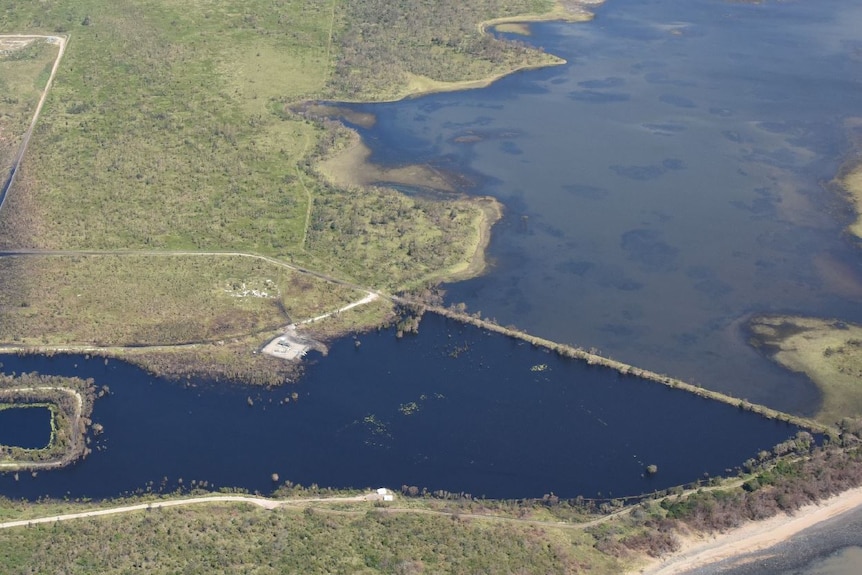 Pond for water and coal capture on the bottom left, the wetland and clear water is to the top right