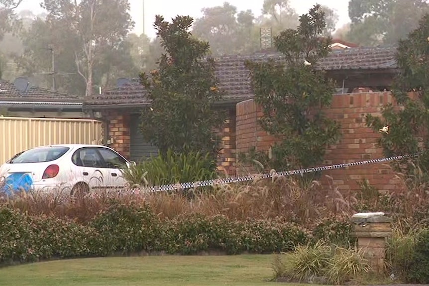 A normal house with police tape across it.