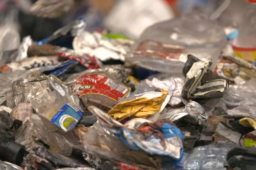 Close-up of a pile of crushed plastic bottles and cans