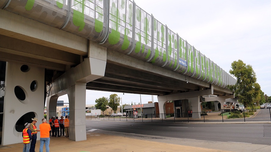 Workmen inspect the South Road overpass.