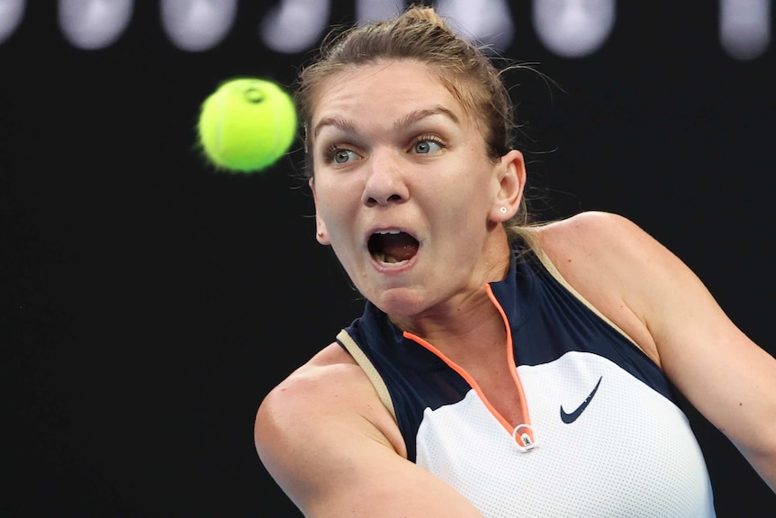 Simona Halep looks at the ball as she prepares to play a backhand return against Serena Williams.