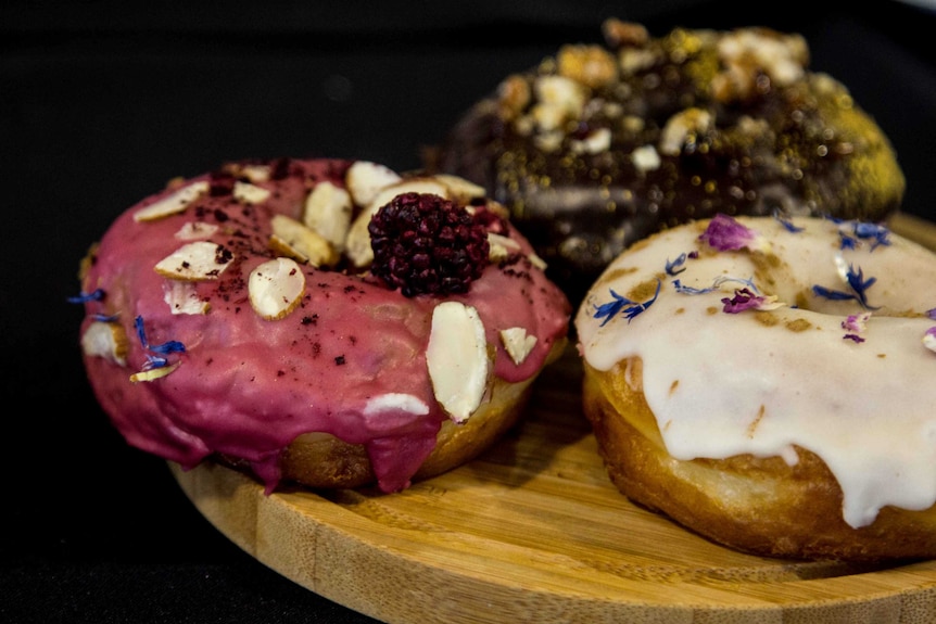 Three iced donuts on a plate