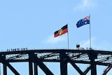 The Australian and Aboriginal flags fly on the Sydney Harbour Bridge