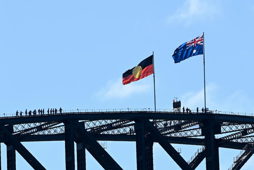 The Australian and Aboriginal flags fly on the Sydney Harbour Bridge