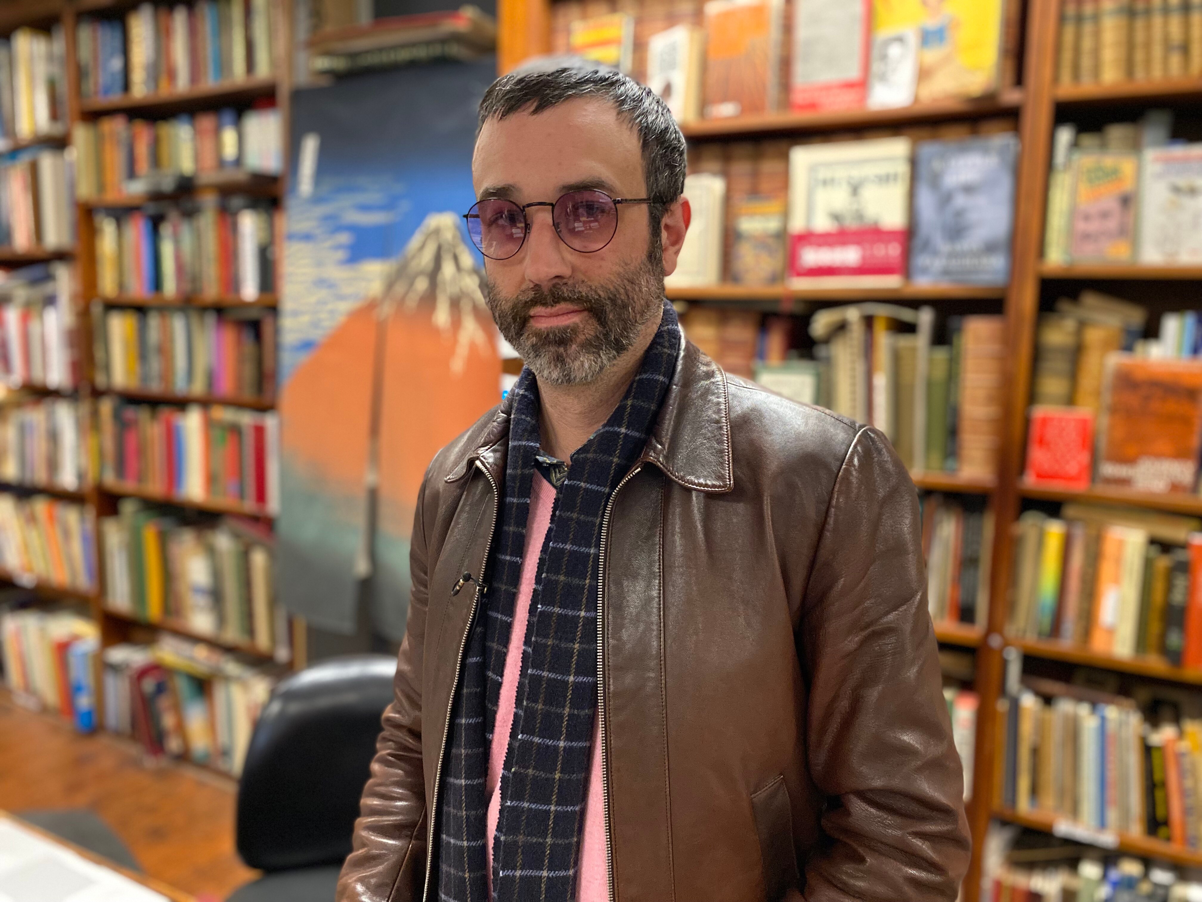 A man dressed in a coat looks.