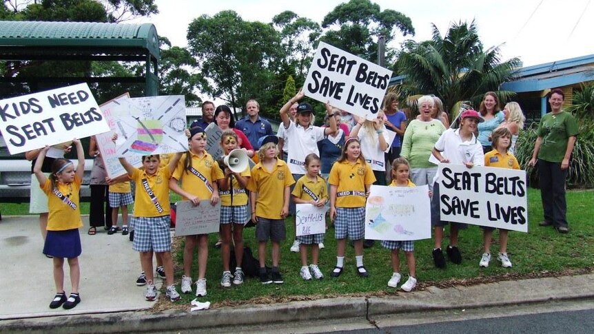 School children hold banners Seat Belts Save Lives during a protest in 2010 on the New South Wales South Coast