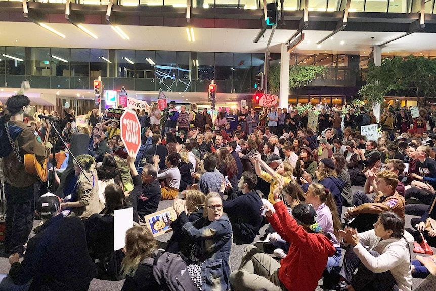Hundreds of anti-Adani protesters gather near ABC Brisbane at South Bank.