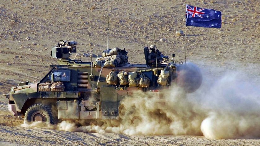 A Bushmaster Infantry Mobility Vehicle drives through a patch of bulldust in Afghanistan