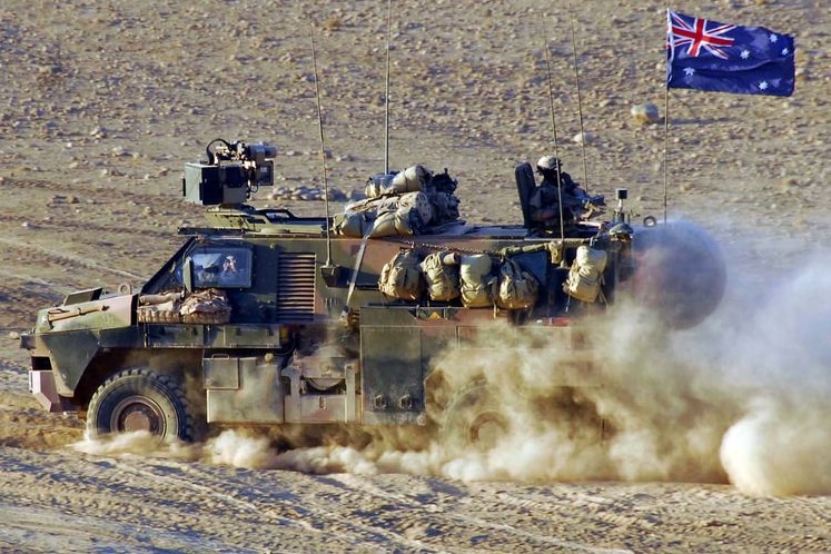 A Bushmaster Infantry Mobility Vehicle drives through a patch of bulldust in Afghanistan